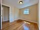 A bright bedroom, with hardwood floors, baseboard trim, and natural light from a window at 1801 S Grove St, Denver, CO 80219