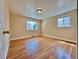 Cozy bedroom with gleaming hardwood floors and two bright windows at 1801 S Grove St, Denver, CO 80219