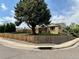Charming home with mature trees, fenced yard, and well-maintained landscaping at 1801 S Grove St, Denver, CO 80219
