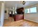 Open-concept kitchen with dark cabinetry, hardwood floors, and ample natural light at 1801 S Grove St, Denver, CO 80219