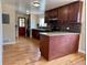 Spacious kitchen featuring hardwood floors, granite countertops, and stainless steel appliances at 1801 S Grove St, Denver, CO 80219