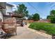 Cozy backyard with stone patio, large grassy area, and comfortable outdoor furniture at 9040 Raleigh St, Westminster, CO 80031