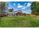 Large backyard featuring lawn space, multiple decks, and mature trees at 9040 Raleigh St, Westminster, CO 80031