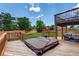 Backyard deck features a hot tub, seating area, and wooden privacy fencing at 9040 Raleigh St, Westminster, CO 80031