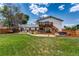 Backyard showcases a multi-level deck, hot tub, seating, and lush lawn at 9040 Raleigh St, Westminster, CO 80031