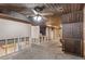Basement with exposed beam ceiling, wood paneling, and unfinished walls at 9040 Raleigh St, Westminster, CO 80031
