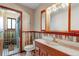 Updated bathroom featuring decorative wood paneling and a modern vanity with stylish fixtures at 9040 Raleigh St, Westminster, CO 80031