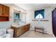 Functional bathroom with double sink vanity and bright lighting at 9040 Raleigh St, Westminster, CO 80031