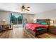 Bright bedroom featuring hardwood floors, deck access, and a ceiling fan at 9040 Raleigh St, Westminster, CO 80031
