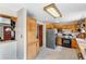 Well-lit kitchen with classic wood cabinetry, modern stainless steel refrigerator, and gas range at 9040 Raleigh St, Westminster, CO 80031