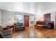 Spacious living room with hardwood floors, comfortable seating, and plenty of natural light at 9040 Raleigh St, Westminster, CO 80031