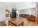 Inviting living room with hardwood floors, comfortable seating, and a view into the kitchen at 9040 Raleigh St, Westminster, CO 80031