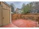 Fenced backyard with a wooden deck, offering privacy and outdoor living space at 15566 E Louisiana Ave, Aurora, CO 80017