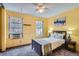 Bedroom with two windows, ceiling fan, and a comfortable bed at 15566 E Louisiana Ave, Aurora, CO 80017