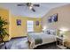 Bedroom with vaulted ceilings, ceiling fan, and large window providing natural light at 15566 E Louisiana Ave, Aurora, CO 80017