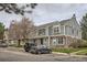 View of multiple townhouses with varied siding and stone accents on a tree-lined street with parking at 15566 E Louisiana Ave, Aurora, CO 80017