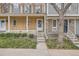 Townhouse entrance with steps leading to the front door, featuring stone accents and manicured landscaping at 15566 E Louisiana Ave, Aurora, CO 80017