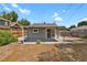 View of the home's backyard with patio area, a small lawn and perimeter fence at 127 S Perry St, Denver, CO 80219