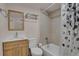 Bathroom featuring shower over tub, and vanity with storage at 127 S Perry St, Denver, CO 80219