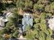 Aerial view of a luxury gray roof home nestled within a lush canopy of verdant trees at 484 Hyland Dr, Castle Rock, CO 80108