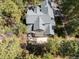 Aerial view showing a patio and deck overlooking a beautiful lot surrounded by mature trees at 484 Hyland Dr, Castle Rock, CO 80108