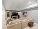Finished basement featuring a cozy sectional sofa, a wooden accent wall, and a large-screen television at 484 Hyland Dr, Castle Rock, CO 80108