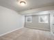 This finished basement room boasts neutral walls, two bright windows, and clean flooring at 484 Hyland Dr, Castle Rock, CO 80108
