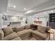 Open-concept finished basement with a bar area, pool table, and a comfortable sectional sofa for versatile living at 484 Hyland Dr, Castle Rock, CO 80108