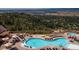 Beautiful aerial view of community pool and lounging area with mountainous views in the background at 484 Hyland Dr, Castle Rock, CO 80108