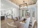 Dining room with wood-paneled ceiling, stylish lighting, and ample space for gathering at 484 Hyland Dr, Castle Rock, CO 80108