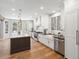Bright kitchen with an island, white cabinetry, stainless steel appliances, and hardwood floors at 484 Hyland Dr, Castle Rock, CO 80108