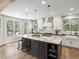 Bright kitchen featuring a large island with seating, modern appliances, and beautiful hardwood floors at 484 Hyland Dr, Castle Rock, CO 80108