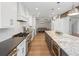 Spacious kitchen with a large island, white cabinets, stainless steel appliances, and hardwood floors at 484 Hyland Dr, Castle Rock, CO 80108
