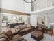 Spacious living room featuring leather furniture, hardwood floors, and large windows with great natural light at 484 Hyland Dr, Castle Rock, CO 80108