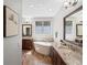 Luxurious main bathroom with double vanities, granite countertops, soaking tub and tile floors at 484 Hyland Dr, Castle Rock, CO 80108
