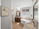 Luxurious main bathroom with double vanities, granite countertops, soaking tub and tile floors at 484 Hyland Dr, Castle Rock, CO 80108
