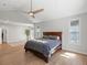 Bright main bedroom featuring a large bed, hardwood floors, and ample natural light from large windows at 484 Hyland Dr, Castle Rock, CO 80108