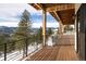 Spacious deck with mountain views and wooden flooring at 26467 Bell Park Dr, Evergreen, CO 80439