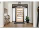 Bright and airy entryway with wood floors and modern console table at 26467 Bell Park Dr, Evergreen, CO 80439