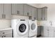 Bright laundry room with Whirlpool washer and dryer at 26467 Bell Park Dr, Evergreen, CO 80439