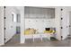 Laundry room with gray cabinets and built-in bench at 26467 Bell Park Dr, Evergreen, CO 80439