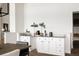 Modern wet bar with white cabinets and granite countertop at 26467 Bell Park Dr, Evergreen, CO 80439