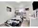 Charming bedroom with a twin-size bed and built-in shelving at 4360 E 70Th Ct, Commerce City, CO 80022