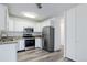 Contemporary kitchen featuring white cabinets, granite counters, and stainless steel appliances at 755 S Alton Way # 9D, Denver, CO 80247