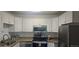 This kitchen features stainless steel appliances, granite countertops and white cabinets at 755 S Alton Way # 9D, Denver, CO 80247