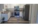 Well-lit kitchen features stainless steel appliances, granite countertops and updated cabinets and flooring at 755 S Alton Way # 9D, Denver, CO 80247