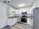 Well-lit kitchen featuring white cabinets, stainless steel appliances, and granite countertops at 755 S Alton Way # 9D, Denver, CO 80247