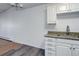 Bright kitchen area with granite counters and white cabinets, next to living space at 755 S Alton Way # 9D, Denver, CO 80247