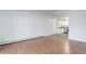Living room with hardwood floors flowing into a kitchen area with white cabinets and stainless steel appliances at 755 S Alton Way # 9D, Denver, CO 80247