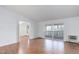Open living room showcasing the hardwood floors and a sliding door for balcony access at 755 S Alton Way # 9D, Denver, CO 80247